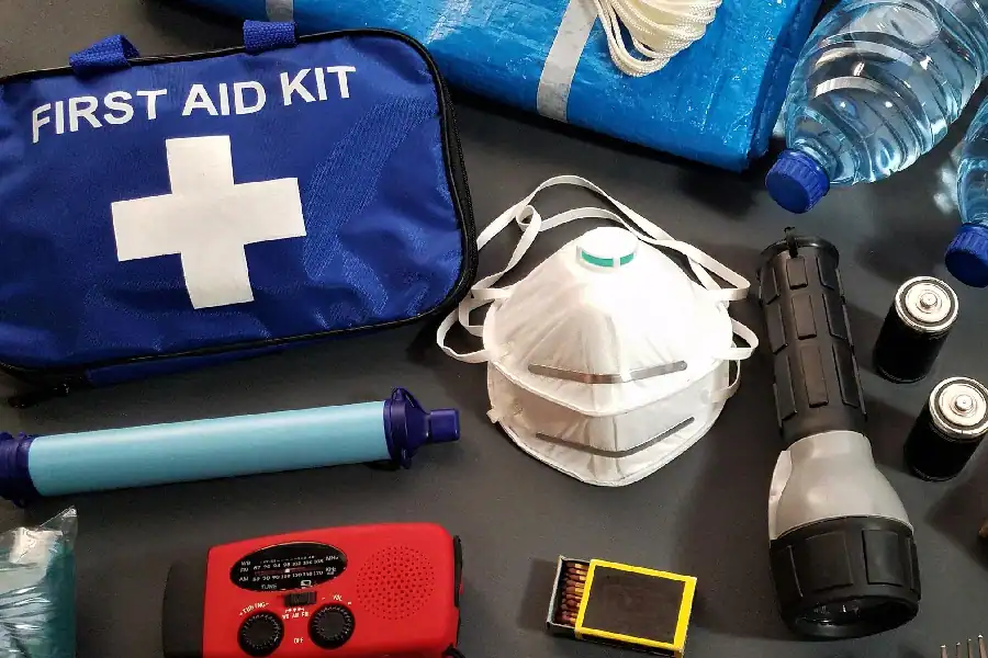 Emergency storm shelter supplies including water flashlight batteries and first aid kit