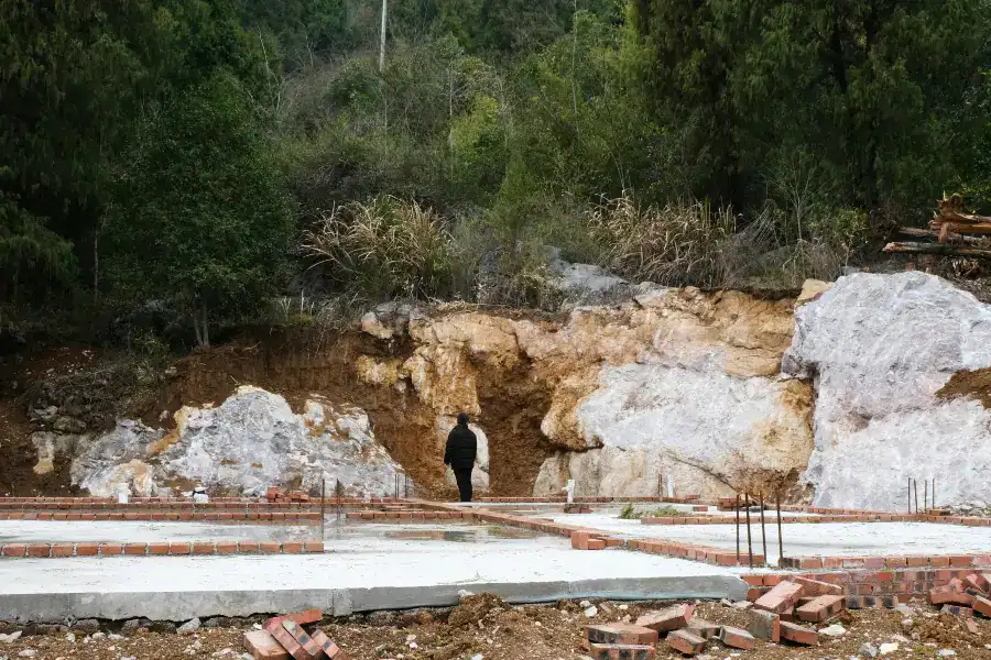 Residential excavation and foundation preparation before storm shelter installation